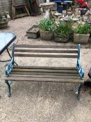 A GARDEN BENCH WITH BLUE PAINTED IRON SUPPORTS`