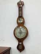A MAHOGANY CASED WHEEL BAROMETER WITH A BRASS BEZEL ENCLOSING THE DIAL