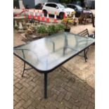 A LARGE GLASS TOP TABLE