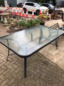 A LARGE GLASS TOP TABLE
