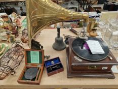 AN HMV WIND UP GRAMOPHONE WITH A BRASS HORN, A HAND BELL, A PAIR OF GLASS AND WIRE SHADES, AN ORMOLU