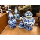 A TALL DELFT BLUE AND WHITE VASE AND A SIMILAR LIDDED URN