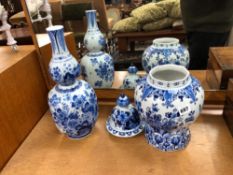 A TALL DELFT BLUE AND WHITE VASE AND A SIMILAR LIDDED URN