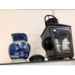 A BLACK METAL RAILWAY LANTERN CONVERTED TO ELECTRICITY TOGETHER WITH A BLUE AND WHITE JUG