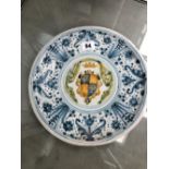 A ANTIQUE DELFT PLATE WITH ARMORIAL CENTRE.