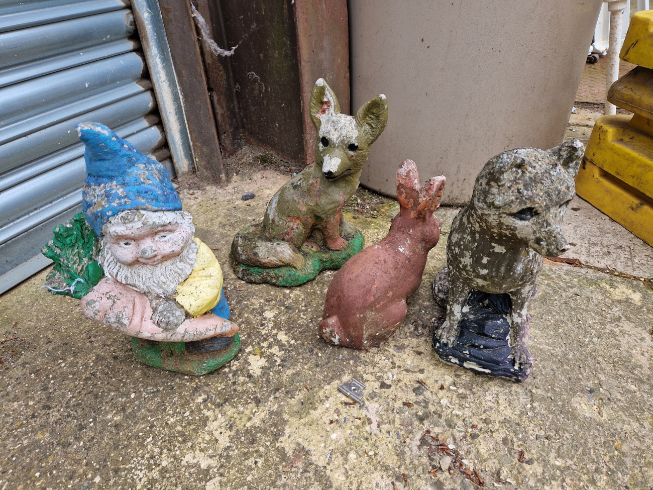 FOUR STONE GARDEN ORNAMENT FIGURES.