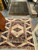 AN ORIENTAL RUG OF BOKHARA DESIGN. 201 x 129cms TOGETHER WITH A TURKISH RUG. 150 x 44cms (2)