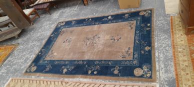 AN ANTIQUE CHINESE RUG. 267 x 190cms TOGETHER WITH AN ORIENTAL CARPET OF KHOTAN DESIGN. 290 x 248cms