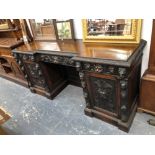 A VICTORIAN CARVED OAK PEDESTAL SIDEBOARD