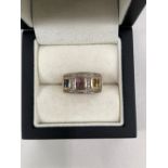 A 9ct HALLMARKED GOLD AND GEMSET CHANNEL SET RING. WEIGHT 4.55grms