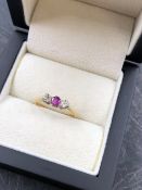 AN 18ct AND PLATINUM THREE STONE RUBY AND DIAMOND RING. THE SHANK WITH 18ct & PLAT STAMPED, MARKS