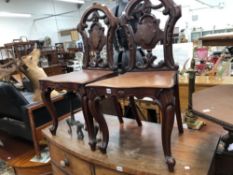 A PAIR OF VICTORIAN MAHOGANY HALL CHAIRS.