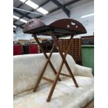 AN ANTIQUE MAHOGANY BUTLERS TRAY ON FOLDING STAND