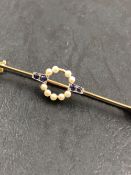 A PEARL AND SAPPHIRE BAR BROOCH. THE BROOCH STAMPED 15ct, ASSESSED AS 15ct GOLD, THE PIN 9ct GOLD.