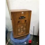 A KOSSOR RADIO IN A PLYWOOD CASE WITH A CIRCULAR CLOTH OVER THE SPEAKER OUTLET, THE CASE. W 43 x D
