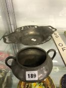 A TUDRIC PEWTER TWO HANDLED SHALLOW DISH TOGETHER WITH A TUDRIC PEWTER TWO HANDLED BOWL