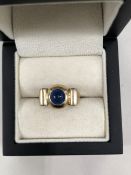 A 9ct HALLMARKED GOLD BLUE STONE CABOCHON SET RING SIGNED UZMAN. WEIGHT 6.26grms.