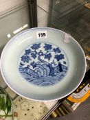 A CHINESE BLUE AND WHITE PLATE PAINTED WITH A FENCED GARDEN SCENE