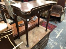 AN ANTIQUE MAHOGANY FOLD OVER GAMES TABLE.