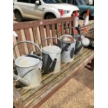 FOUR GALVANIZED WATERING CANS