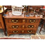 AN ANTIQUE FRENCH INLAID LABURNAM AND EXOTIC WOOD PARQUETRIED THREE DRAWER COMMODE ON ROUNDED ORMOL