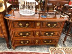AN ANTIQUE FRENCH INLAID LABURNAM AND EXOTIC WOOD PARQUETRIED THREE DRAWER COMMODE ON ROUNDED ORMOL