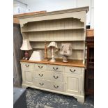 A LARGE PAINTED PINE KITCHEN DRESSER WITH PLATE RACK.