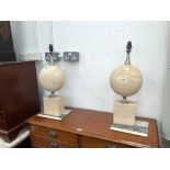 A PAIR OF TABLE LAMPS, EACH WITH CHROME MOUNTS TO COMPRESSED SPHERES OF TUFA AND RECTANGULAR