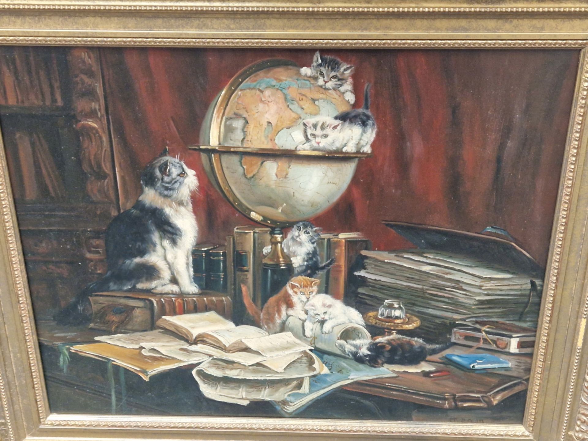A DECORATIVE PAINTING OF CATS PLAYING ON A DESK, OIL ON BOARD. 50 x 61cms