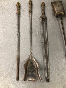 A SET OF THREE POLISHED STEEL FIRE IRONS WITH NEOGOTHIC BRASS HANDLES TOGETHER WITH ANOTHER SET OF