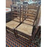 A SET OF FOUR RUSH SEAT LADDER BACK CHAIRS