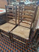 A SET OF FOUR RUSH SEAT LADDER BACK CHAIRS