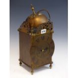 A LANTERN CLOCK, THE MOVEMENT WITH A PLATFORM ESCAPEMENT AND STRIKING ON A BELL. H 38cms.