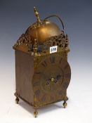 A LANTERN CLOCK, THE MOVEMENT WITH A PLATFORM ESCAPEMENT AND STRIKING ON A BELL. H 38cms.