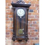 A VIENNA TWO WEIGHT WALL CLOCK IN A GLAZED MAHOGANY WALL MOUNTING CASE. H 100cms.