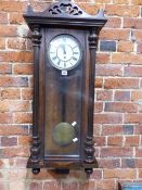 A VIENNA TWO WEIGHT WALL CLOCK IN A GLAZED MAHOGANY WALL MOUNTING CASE. H 100cms.