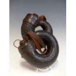 A PAIR OF EMBOSSED LEATHER MOUNTED POWDER HORNS WITH STRAP ATTACHMENTS
