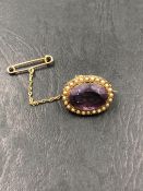 AN ANTIQUE GEMSET AND PEARL 9ct STAMPED BROOCH COMPLETE WITH SAFETY CHAIN. MEASUREMENTS