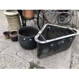 THREE BLACK PAINTED CAST IRON POTS AND A CORNER TROUGH