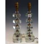 A PAIR OF TABLE LAMPS, EACH WITH GLASS SQUARES FORMING THE STEMS. H 37cms. TOGETHER WITH A SINGLE