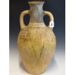 AN ARCHAIC GREEK TWO HANDLED VASE WITH A BLACK PAINTED NECK AND GEOMETRIC DESIGNS ON THE SHOULDERS