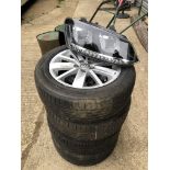 A SET OF FOUR VW POLO ALLOY WHEELS TOGETHER WITH A PAIR OF AS NEW VW POLO HEAD LAMP UNITS