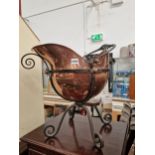AN ANTIQUE COPPER COAL SCUTTLE IN THE MANNER OF CHRISTOPHER DRESSER.