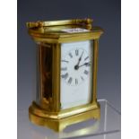 A LEATHER CASED FRENCH CARRIAGE TIMEPIECE, THE NARROW SIDES OF THE BEVELLED GLASS CASE BOWED