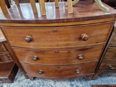 A VICTORIAN MAHOGANY BOW FRONT THREE DRAWER CHEST.