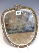 A BEVELLED GLASS SHIELD SHAPED MIRROR IN A CORAL AND TURQUOISE CABOCHON MOUNTED FRAME, THE BACK ONCE