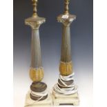 A PAIR OF GREY REEDED COLUMNAR TABLE LAMPS WITH GILT LEAVES ABOVE THE SQUARE WHITE PAINTED BASES