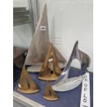 TWO ALUMINIUM MODEL SAILING BOATS TOGETHER WITH THREE OTHERS IN BRASS