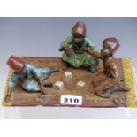 A BERGMAN COLD PAINTED BRONZE GROUP OF THREE MOROCCAN BOYS PLAYING DICE ON A CARPET, B IN A VASE AND