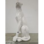 A WHITE GLAZED MODEL OF A SEATED BIG CAT